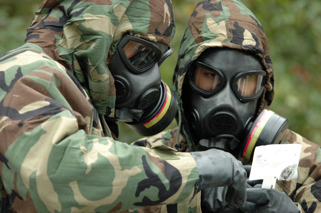 US service members conduct a chemical warfare exercise.
