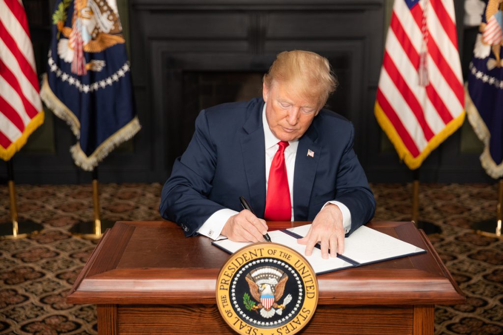 President Trump signs an Executive Order on Iran sanctions on August 5, 2018.
