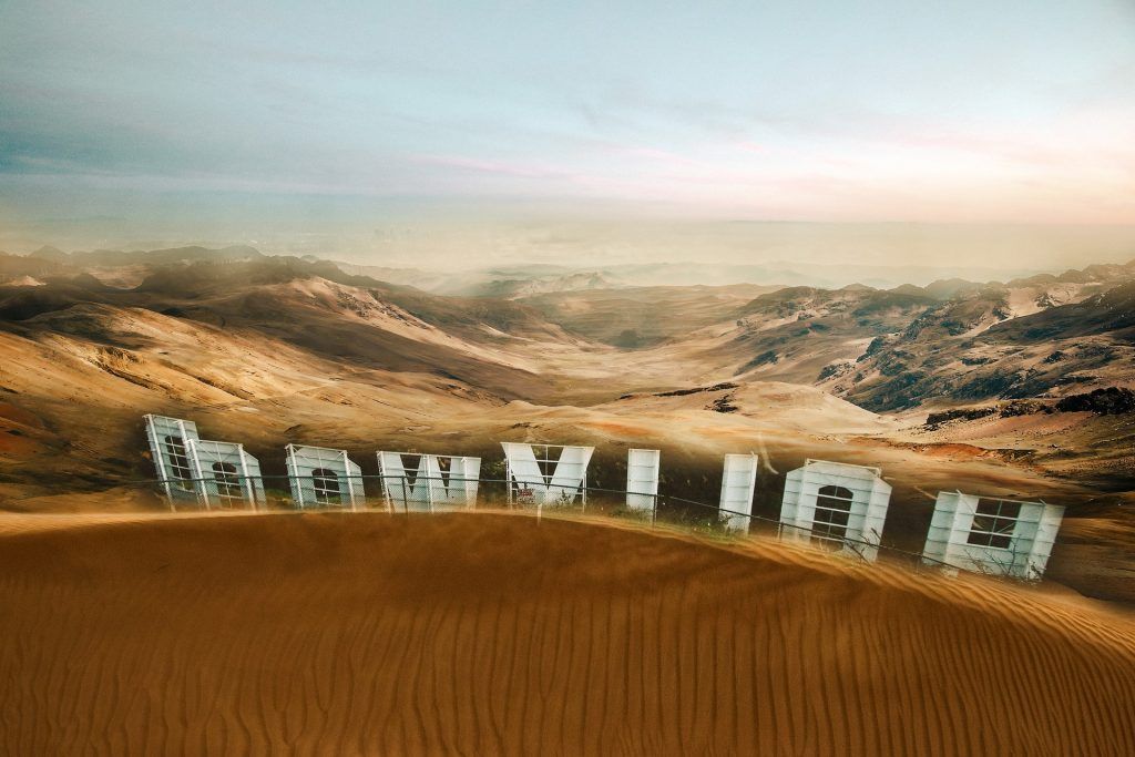 Hollywood sign submerged in sand