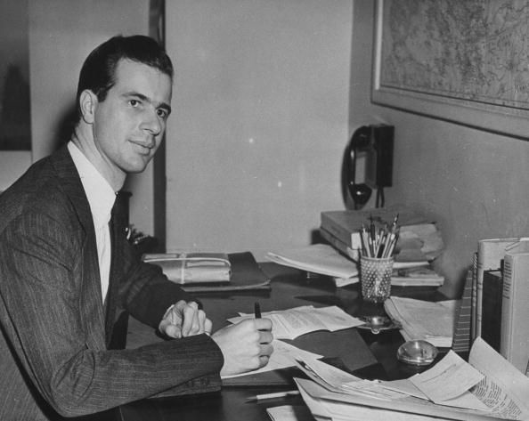 John Hersey at his desk, pen in hand, in the office at TIME. (Photo by Time Life Pictures/Pix Inc./The LIFE Picture Collection/Getty Images)