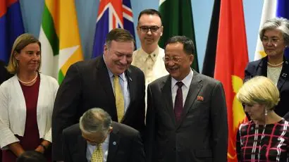 US Secretary of State Mike Pompeo (second from left) chats with North Korea's Foreign Minister Ri Yong Ho (center right) as the European Union's foreign policy chief, Federica Mogherini (left), Philippine Foreign Secretary Alan Peter Cayetano (center behind), Australia's Foreign Minister Julie Bishop (bottom right) and South Korea's Foreign Minister Kang Kyung-wha (top right) look on during the 51st Association of Southeast Asian Nations (ASEAN) Ministerial Meeting (AMM) in Singapore in August 2018. (Photo credit: MOHD RASFAN/AFP/Getty Images.)