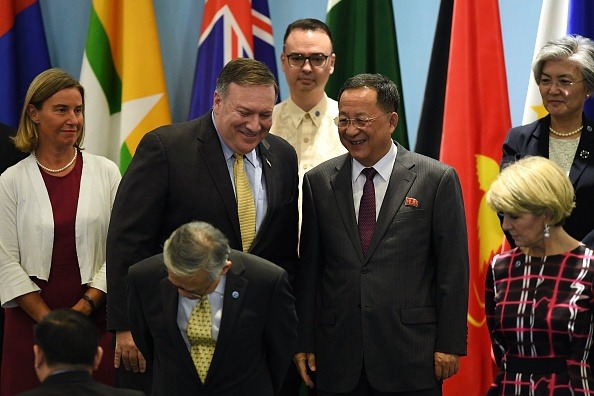 US Secretary of State Mike Pompeo (second from left) chats with North Korea's Foreign Minister Ri Yong Ho (center right) as the European Union's foreign policy chief, Federica Mogherini (left), Philippine Foreign Secretary Alan Peter Cayetano (center behind), Australia's Foreign Minister Julie Bishop (bottom right) and South Korea's Foreign Minister Kang Kyung-wha (top right) look on during the 51st Association of Southeast Asian Nations (ASEAN) Ministerial Meeting (AMM) in Singapore in August 2018. (Photo credit: MOHD RASFAN/AFP/Getty Images.)