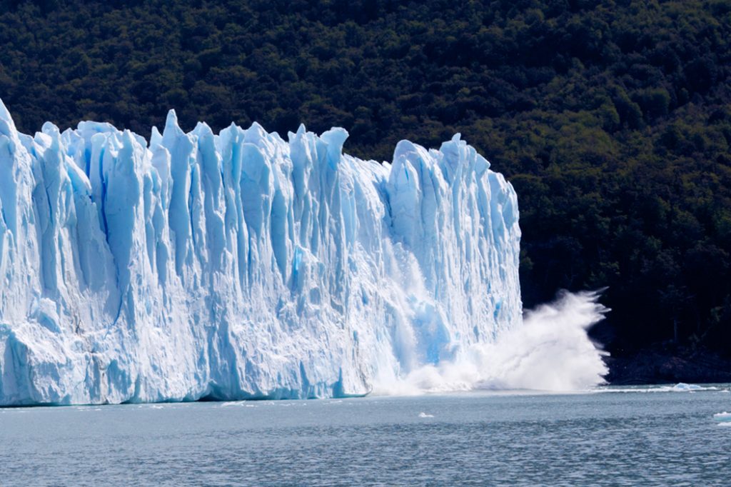 glacier ice falling into sea