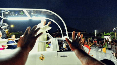 Pope Francis waves to a crowd.