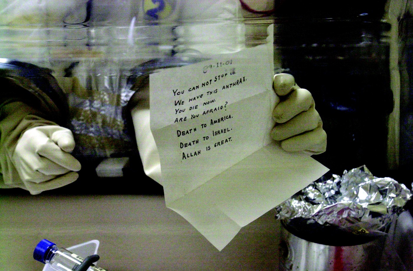 Laboratory technician holding the anthrax-laced letter addressed to Senator Leahy after safely opening it at the U.S. Army's Fort Detrick bio-medical research laboratory in November 2001. FBI