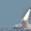 The US military tests a missile in the ocean.