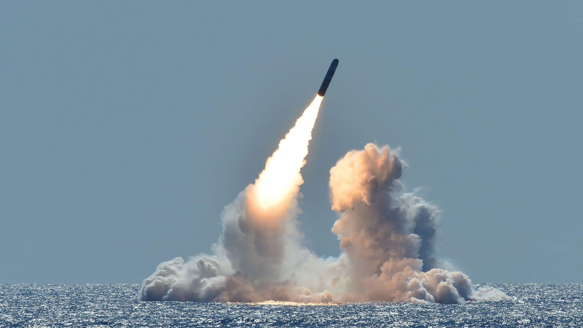 The US military tests a missile in the ocean.