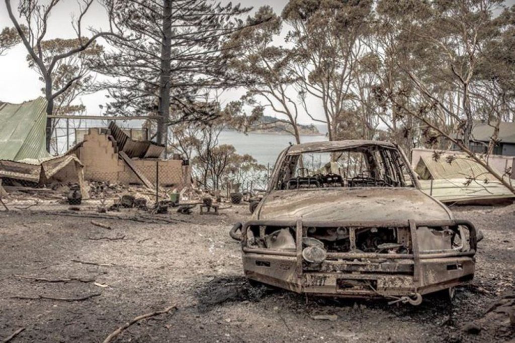 burnt-out car and scorched land