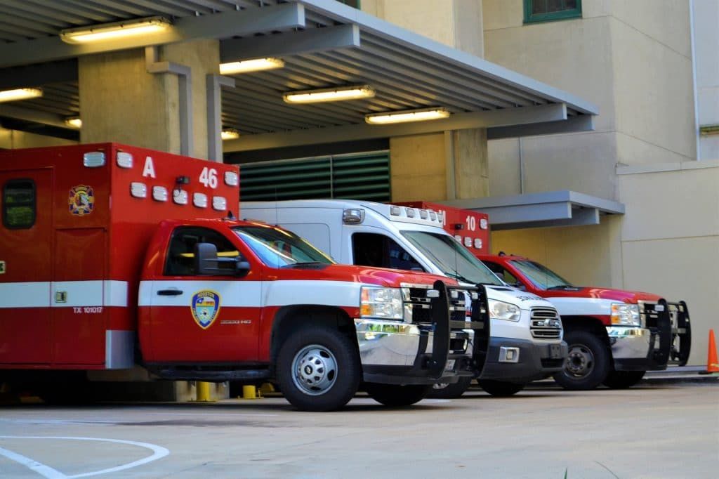 Ambulances wait outside an emergency room.