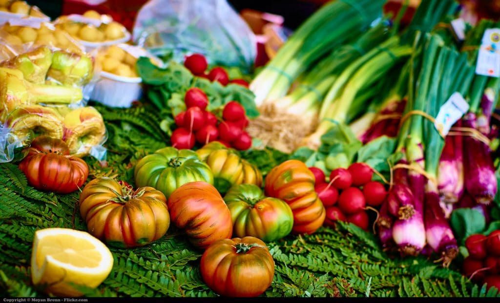 A greengrocer's table, full of vegetables.
