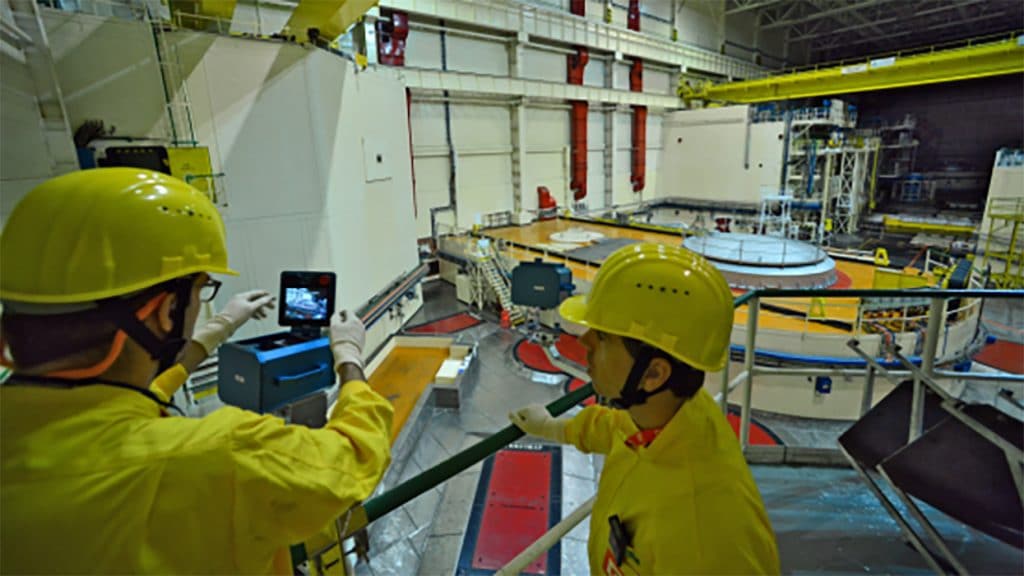 IAEA nuclear safeguards inspectors with remote surveillance equipment