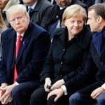 US President Donald Trump and his wife, Melania, look on as German Chancellor Angela Merkel communes with French President Emmanuel Macron during ceremonies commemorating the 100th anniversary of the end of World War I.