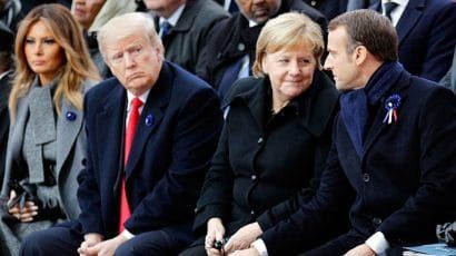 US President Donald Trump and his wife, Melania, look on as German Chancellor Angela Merkel communes with French President Emmanuel Macron during ceremonies commemorating the 100th anniversary of the end of World War I.