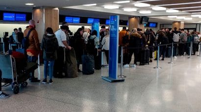 The departure hall of Terminal 7 at JFK airport on March 15 in New York City. Frustrated passengers complained of hours-long lines, crowded and unsanitary conditions and general disarray in the system for screening people for symptoms of the virus.(Photo by Johannes EISELE/AFP via Getty Images)
