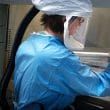 A scientist works at a biosafety level 4 lab.