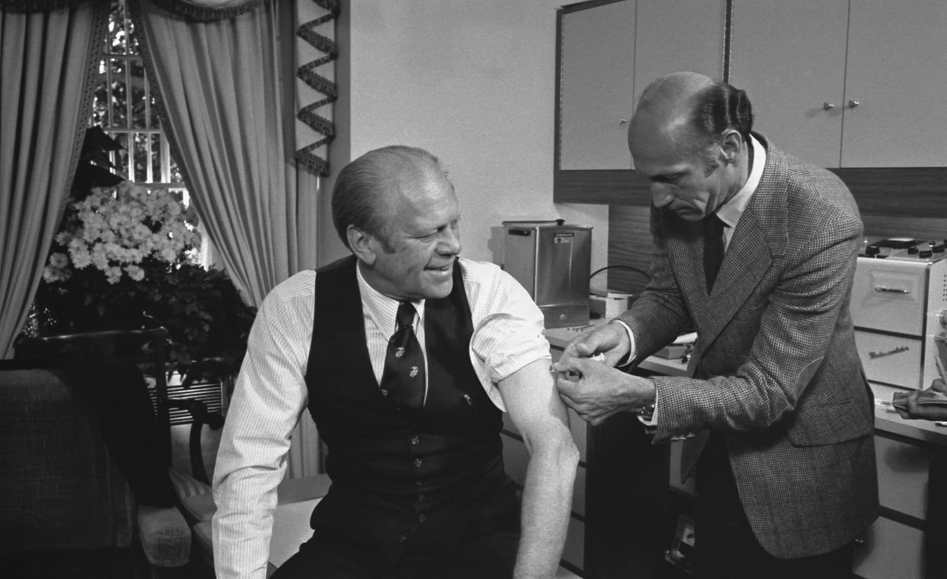 President Ford receives a swine flu inoculation from his White House physician, Dr. William Lukash, on October 14, 1976. (Gerald R. Ford Library)