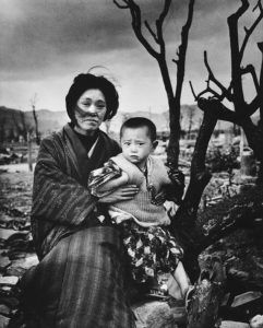A mother and child, dressed in traditional clothing, sit on the ground amid rubble and burnt trees, Hiroshima, Japan, December 1945. On August 6, some four months previously, the United States had dropped an atomic bomb on the city--three days later a second one was dropped on Nagasaki. (Photo by Alfred Eisenstaedt/The LIFE Picture Collection via Getty Images)