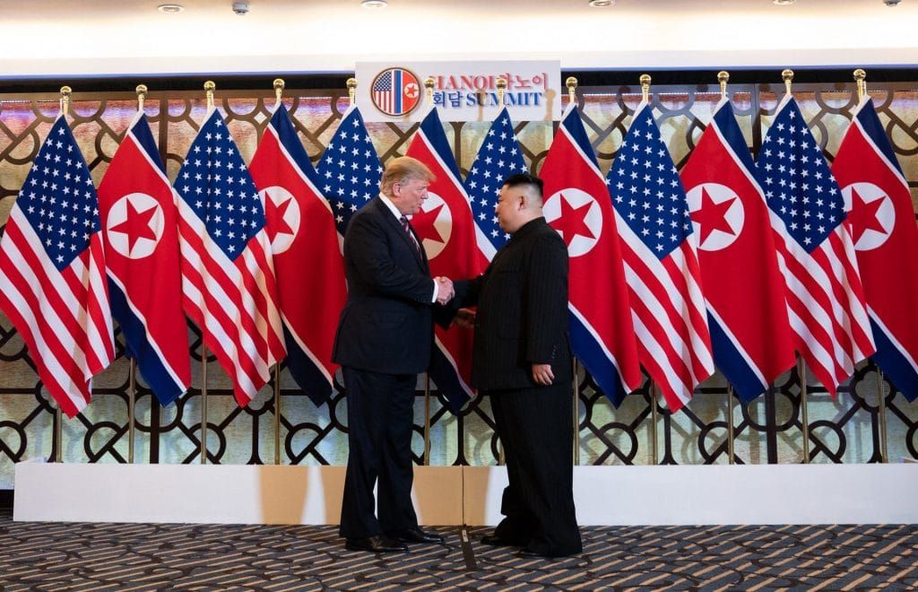 Donald Trump and Kim Jong Un shake hands