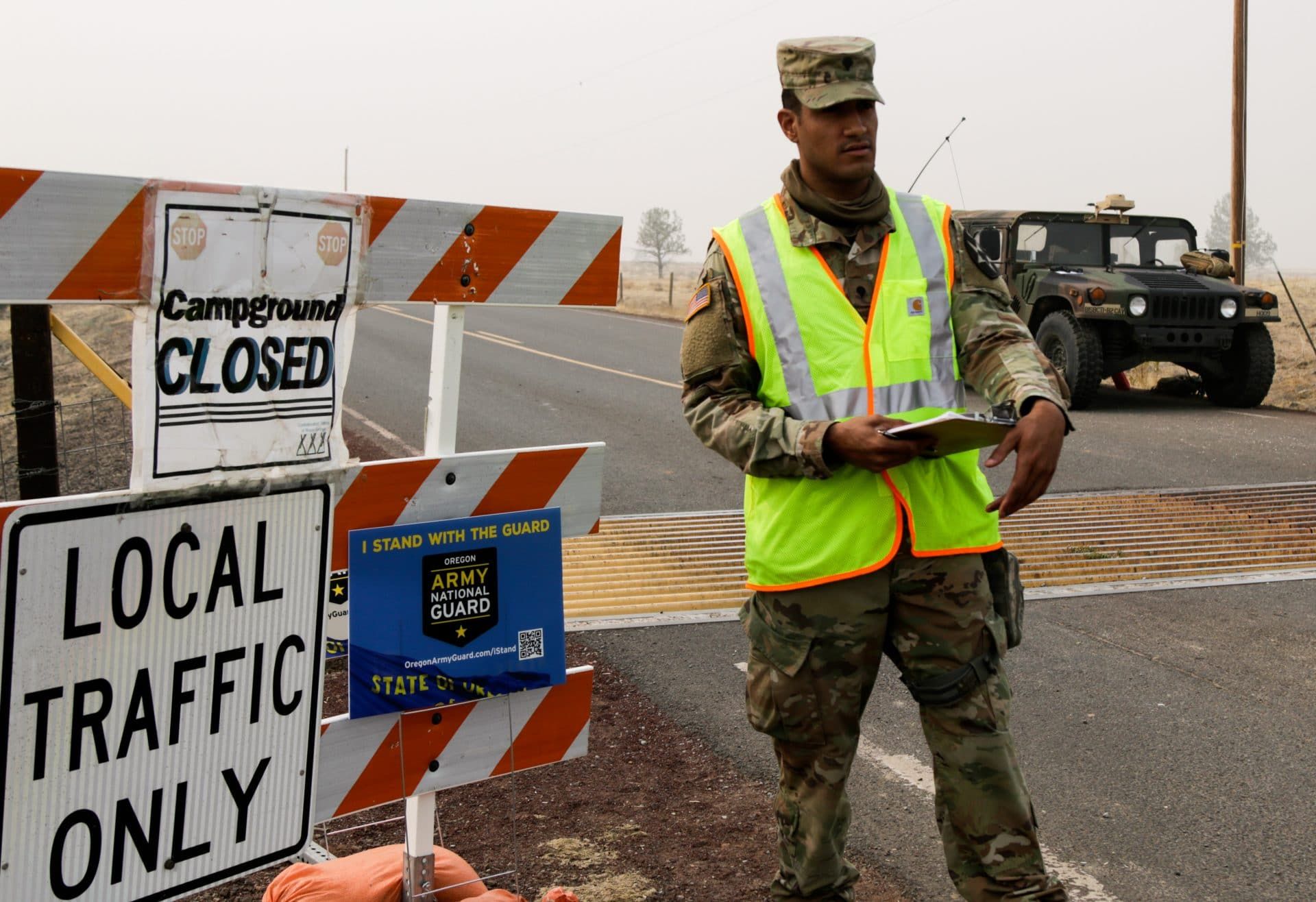 National Guard monitors traffic control point during potential wildfire evacuation