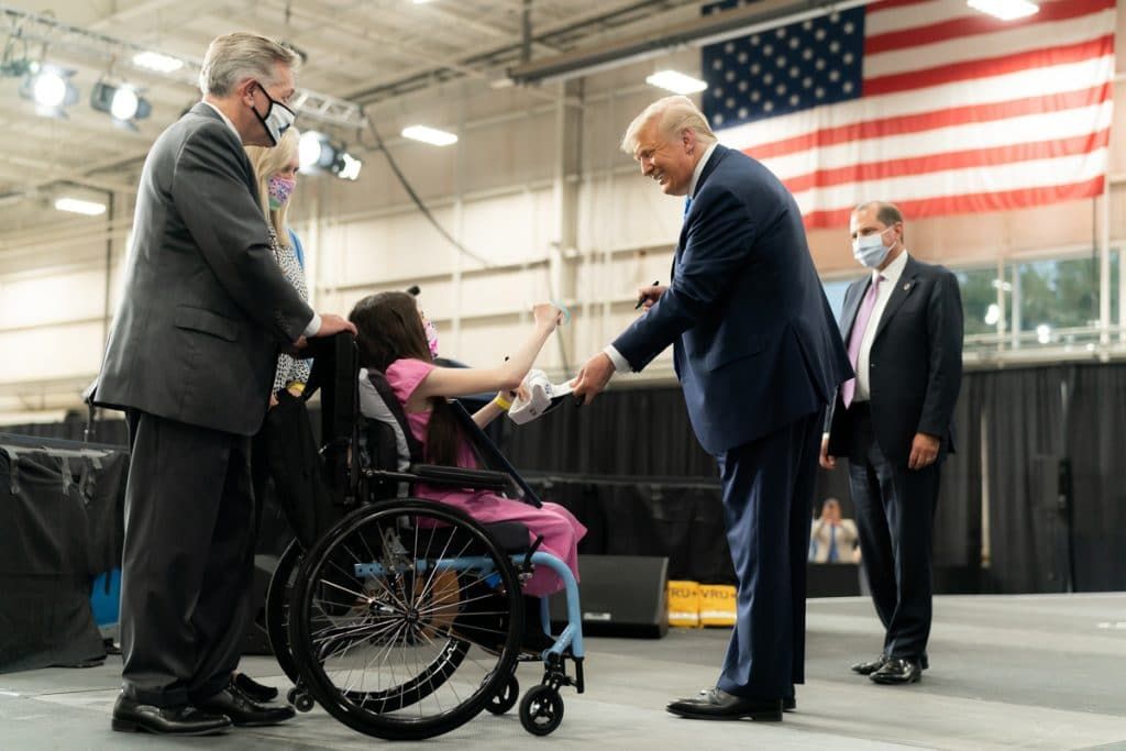 President Trump autographs a hat for a young medical patient