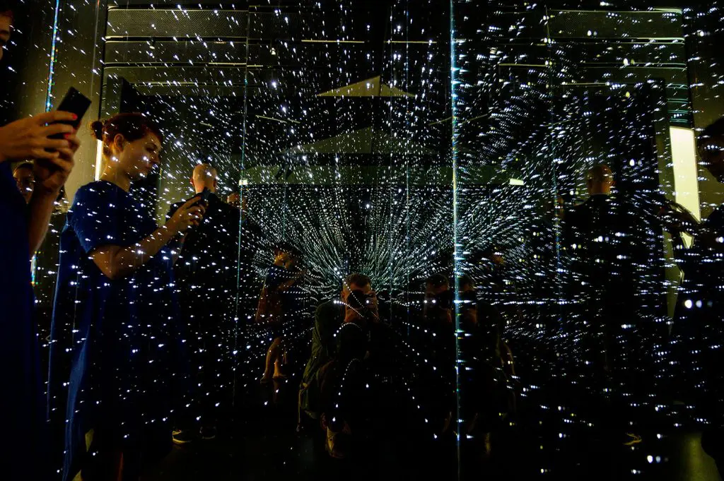 Visitors check out an infinity chamber at the "Futurium" in Berlin, a venue where significant national and international developments in scientific, technical and social research are to be presented and discussed among the government, the scientific community, industry, and society. (Photo credit: JOHN MACDOUGALL/AFP via Getty Images)