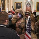 Supporters of US President Donald Trump, including member of the QAnon conspiracy group Jake A, aka Yellowstone Wolf (C), enter the US Capitol on Wednesday. (Photo by SAUL LOEB/AFP via Getty Images)