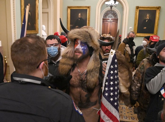 Supporters of US President Donald Trump, including member of the QAnon conspiracy group Jake A, aka Yellowstone Wolf (C), enter the US Capitol on Wednesday. (Photo by SAUL LOEB/AFP via Getty Images)