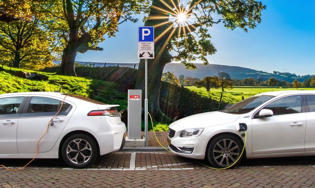 electric cars charging and idyllic backdrop