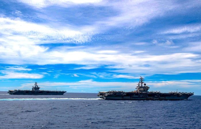 The aircraft carriers USS Nimitz and USS Ronald Reagan transit the South China Sea in July 2020. (Photo credit: US Navy)