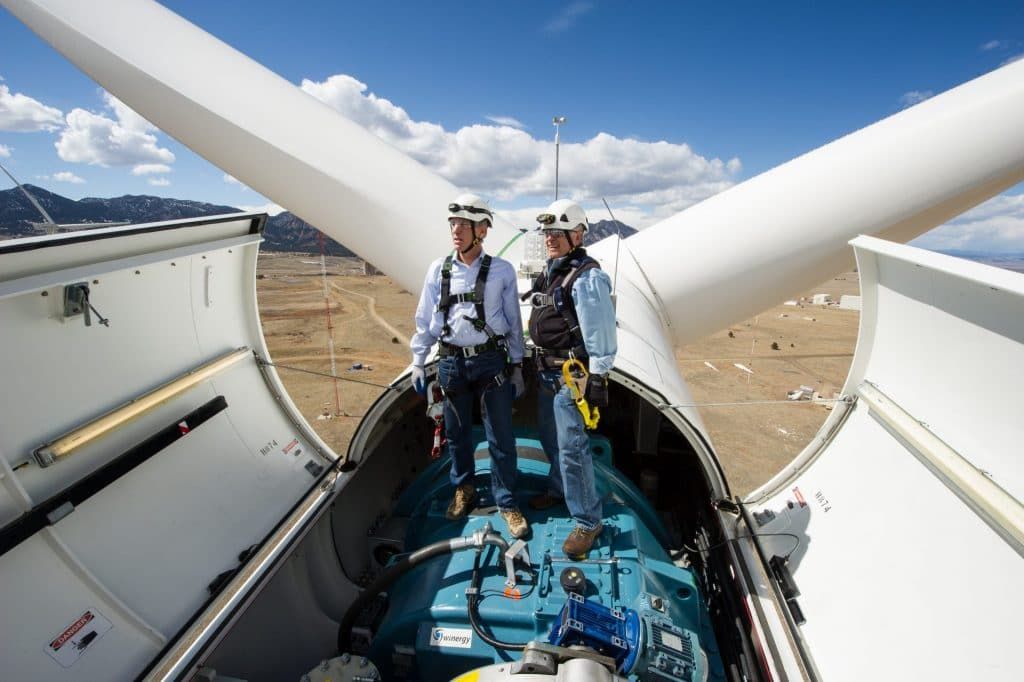 engineers inside top of wind turbine