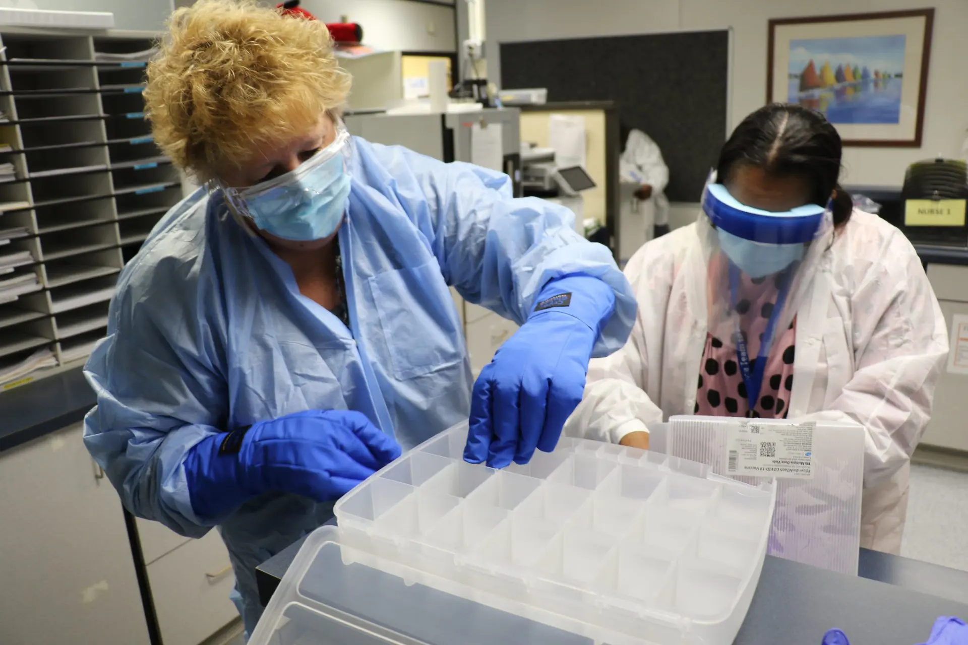 Health workers in North Carolina handle a delivery of COVID-19 vaccines