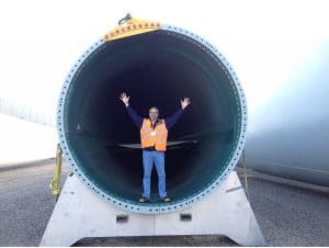 man inside blade of wind turbine ashore