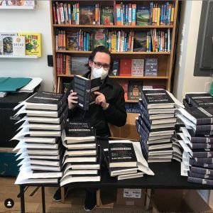 Alex Wellerstein (in a mask due to the COVID-19 pandemic) signs copies of his book, Restricted Data: The History of Nuclear Secrecy in the United States. Photo permission: Alex Wellerstein. 