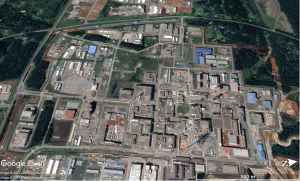 Figure 3. August 16, 2019 satellite image of the central area of Japan’s $30-billion reprocessing and mixed-oxide-fuel production complex in Rokkasho Village, Japan. The white arrow shows the foundation hole for the mixed-oxide-fuel fabrication plant (Map Data: Google 2021 CNES/Airbus, Maxamar Technologies).