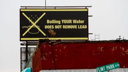 A sign tells Flint, Mich. residents that boiling water doesn't remove lead in Februaary 2016 Months earlier, the city told citizens they could use tap water if they boiled it first. (Photo by Sarah Rice/Getty Images)