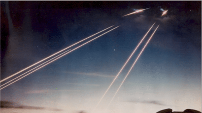 Time exposure showing the tracks of the missiles’ six dummy warheads, white-hot from air friction, arriving 8,000 km down-range near Kwajalein Atoll in the Western Pacific. The domes in the foreground house tracking telescopes. As a part of the post-Cold War reductions, the Minuteman IIIs were downgraded to one warhead each. Credit: US Air Force photos from National Security Archive and US National Archive collections respectively. Public domain image.