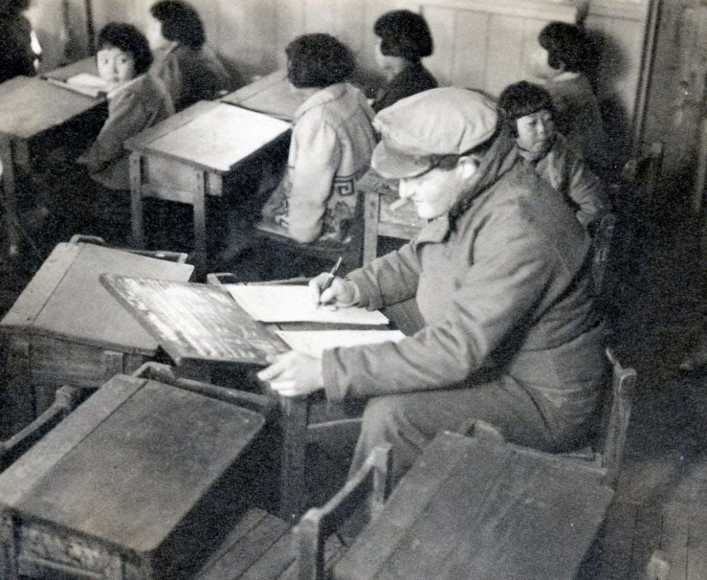 Herbert Sussan in a newly-reopened school room during filming in Nagasaki in 1946. (Credit: US Army)