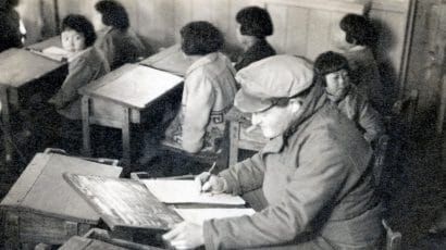Herbert Sussan in a newly-reopened school room during filming in Nagasaki in 1946. (Credit: US Army)