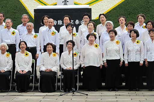 A choir of Hibakusha (atomic bomb survivors) sing "Never Again." Hiroshima-Nagasaki 2012. Credit: The Official CTBTO Photostream. Accessed via Wikimedia Commons.