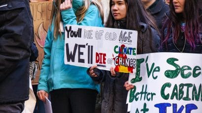 Youth holding signs at climate protest