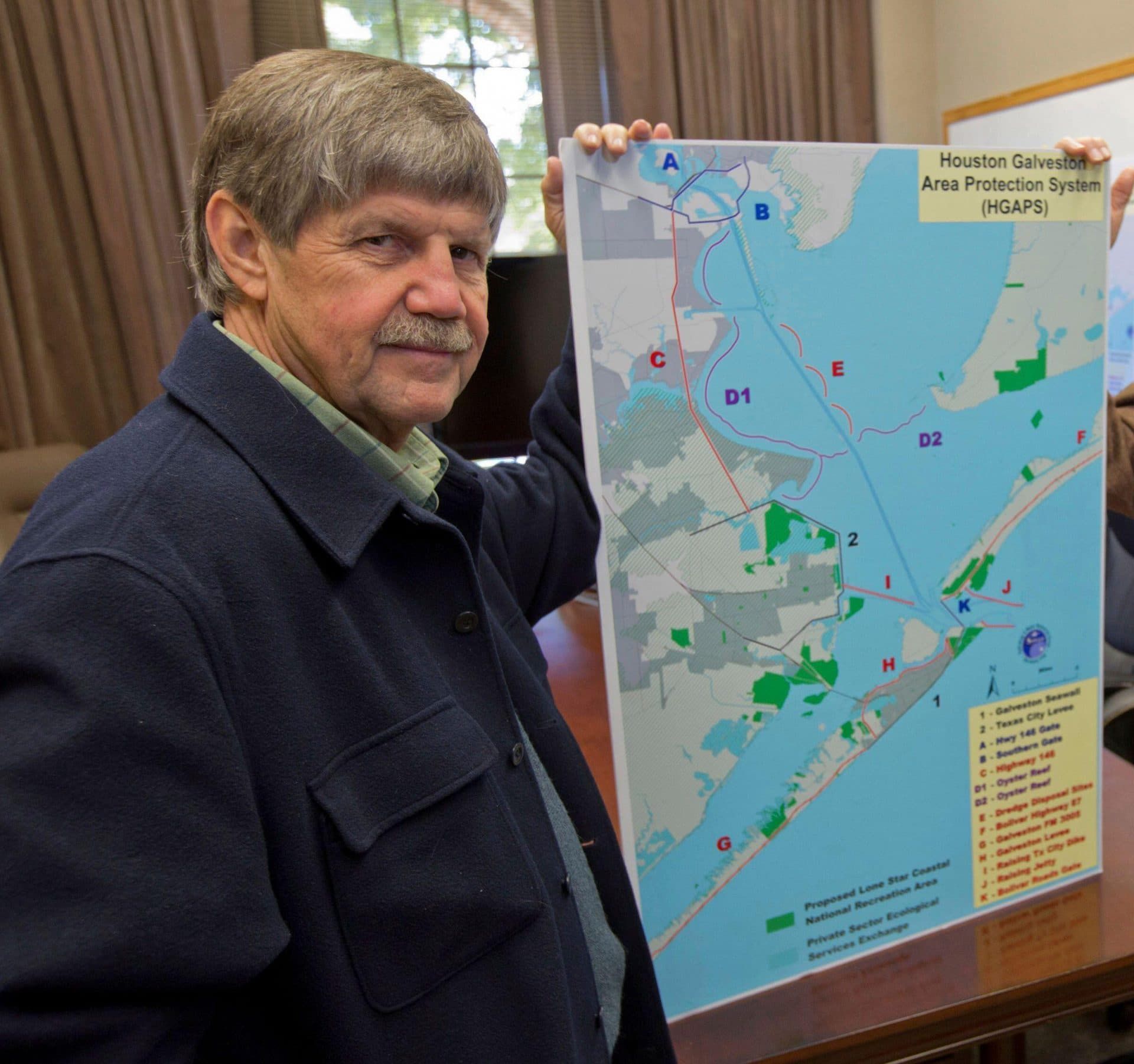 Jim Blackburn, professor of Environmental Law at Rice University poses with a Houston Galveston Area Protection System (HGAPS) map. (Reuters/Richard Carson)