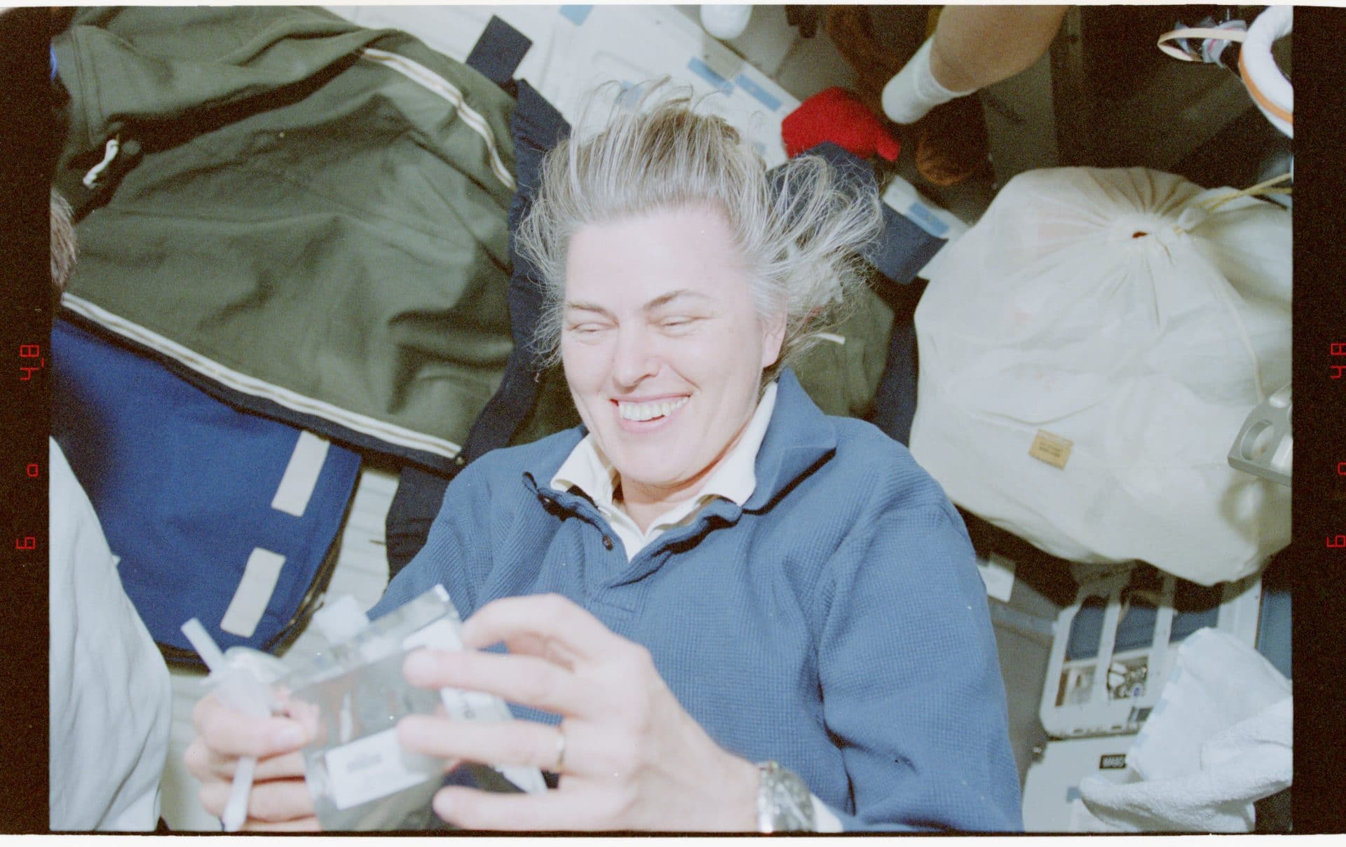 a female astronaut with packaged food