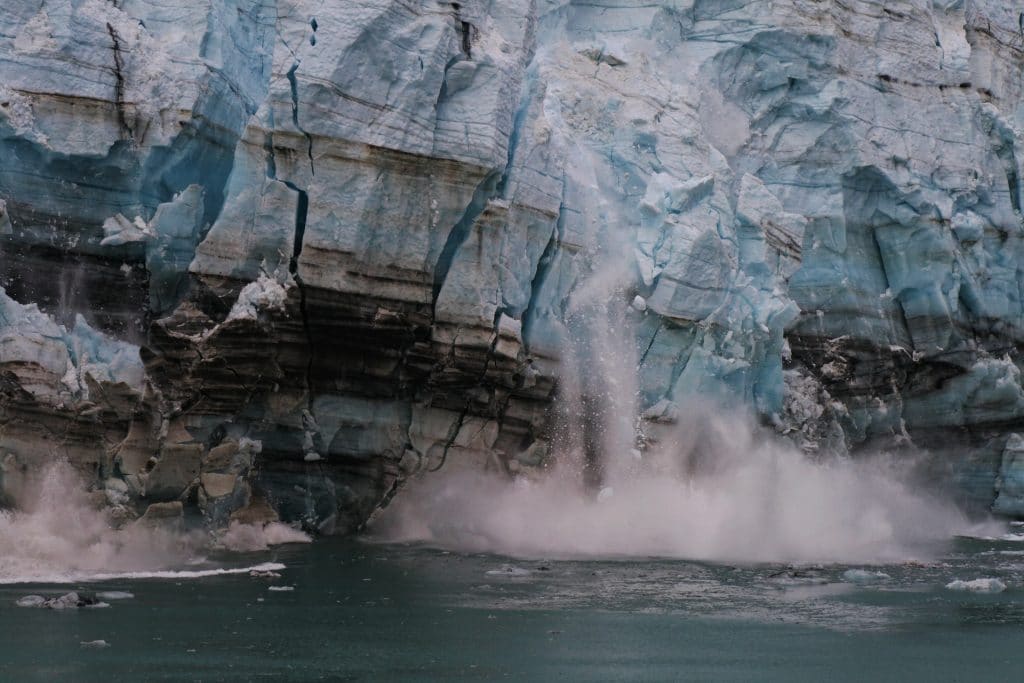 Part of a glaciar breaks off into the ocean