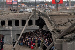 Ukrainian civilians and soldiers take shelter under a bridge in Kyiv. March 5, 2022. Credit: Міністерство внутрішніх справ України. Accessed via Wikimedia Commons. CC BY 4.0.