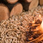wood pellets burning, logs in background