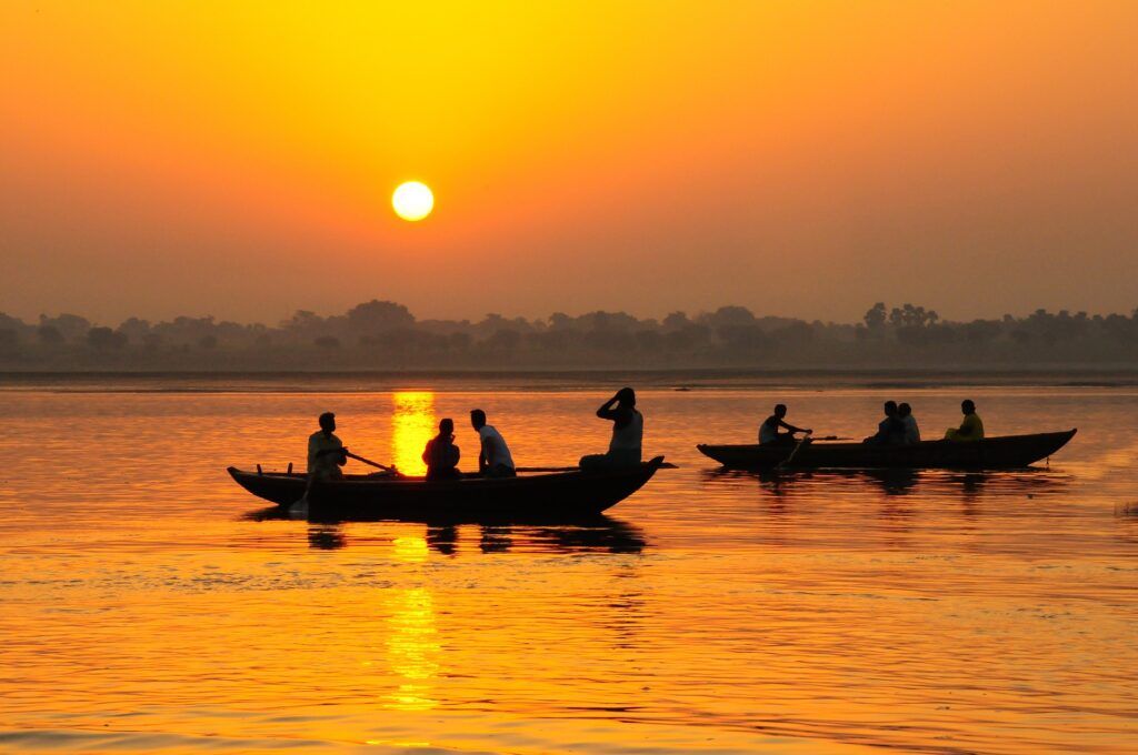 silhouettes of boats on the Ganges River