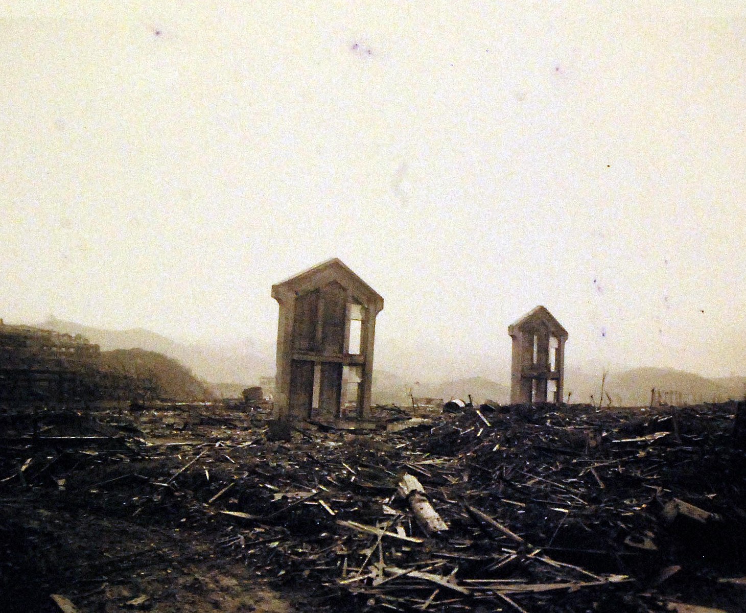 Atomic Bomb-Nagasaki, 1945. Two lonely, upright sentinels in the ocean of rubble, where the atomic bomb exploded. They may have been part of a school, warehouse or industrial plant. Photographed by September 16, 1945. Official U.S. Marine Corps Photograph, now in the collections of the National Archives. (2016/10/25). Image courtesy Wikimedia Commons.
