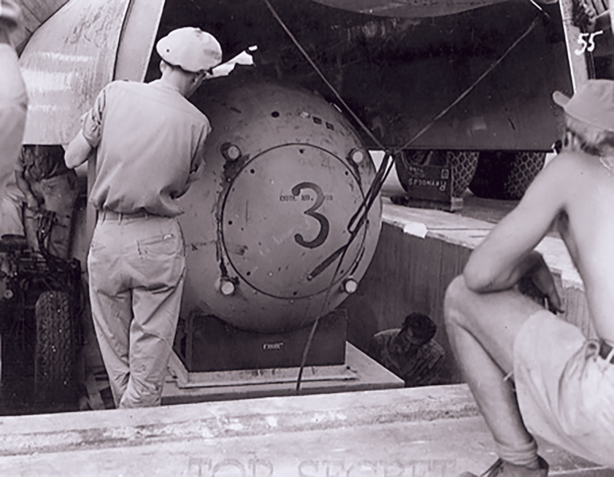 A "Fat Man" test unit being raised from the pit into the bomb bay of a B-29 for bombing practice during the weeks before the attack on Nagasaki. (Photo from U.S. National Archives, RG 77-BT)