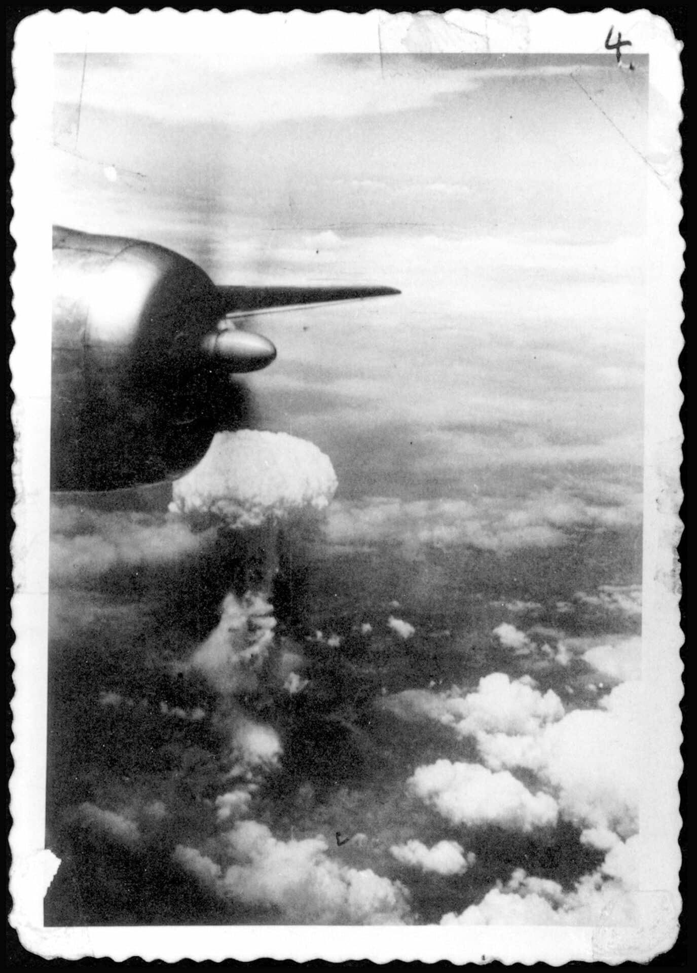 When Bockscar finally made it to the target site—the city of Nokumura—it was covered by fog, haze, and possibly a smokescreen created by the Japanese burning of coal tar. The crew had to make a visual drop; they tried three times, then gave up and went to their alternate target: Nagasaki. That, too, was covered by cloud, until a gap suddenly appeared. The bombardier released the Fat Man atomic bomb over Nagasaki, and at 12:02 pm on August 9, 1945, it exploded at an altitude of 1,840 feet with a force equal to about 22,000 tons of TNT. Unfortunately, with no photo plane, the only images that were available were those taken with an amateur camera smuggled aboard Bockscar. Photo courtesy of Los Alamos National Laboratory.