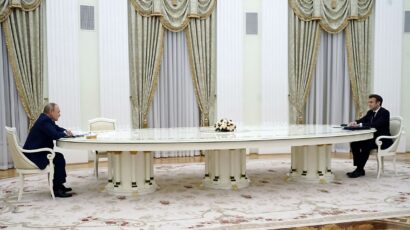 Putin at 20-foot long table with Macron